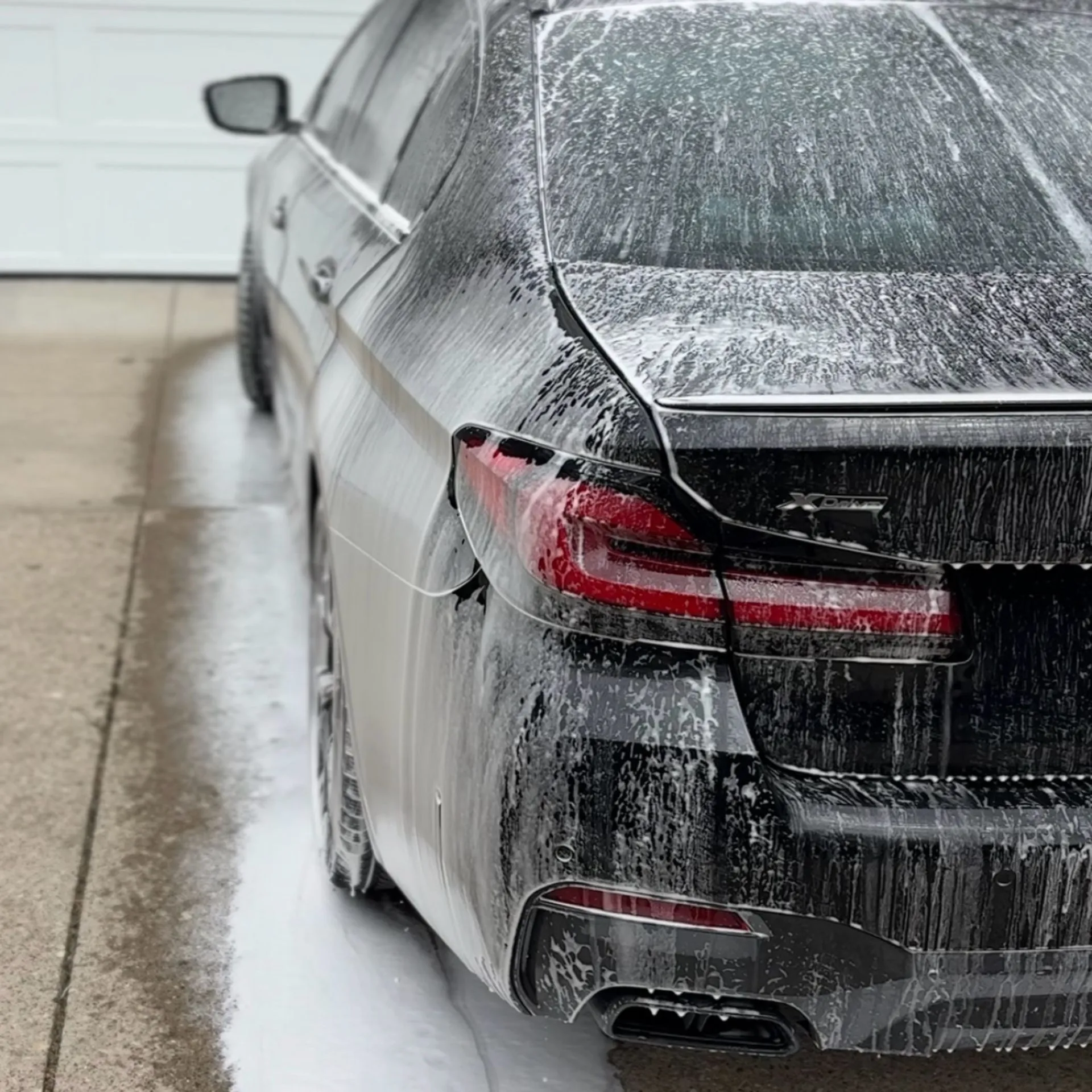 Ceramic coating foam wash on black BMW