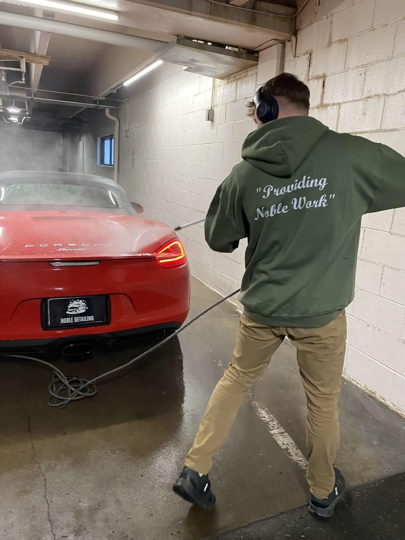 Luxury vehicle being hand-washed by Noble Detailing in Des Moines